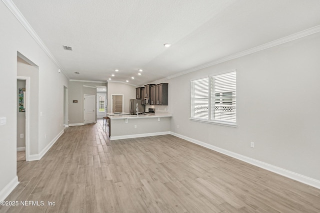 285 Greenway Ln, Saint Augustine, FL 32092 - unfurnished living room with light wood-style floors, a sink, crown molding, baseboards, and recessed lighting