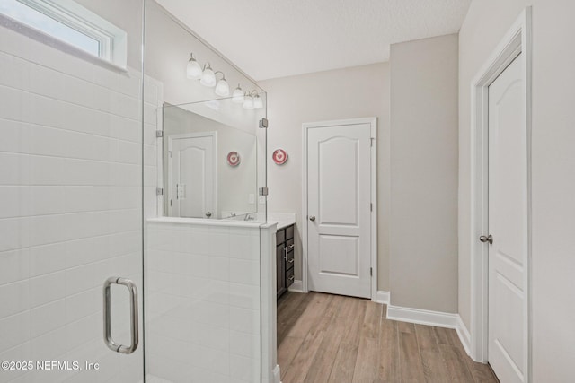 285 Greenway Ln, Saint Augustine, FL 32092 - full bath featuring wood finished floors, vanity, baseboards, and a stall shower