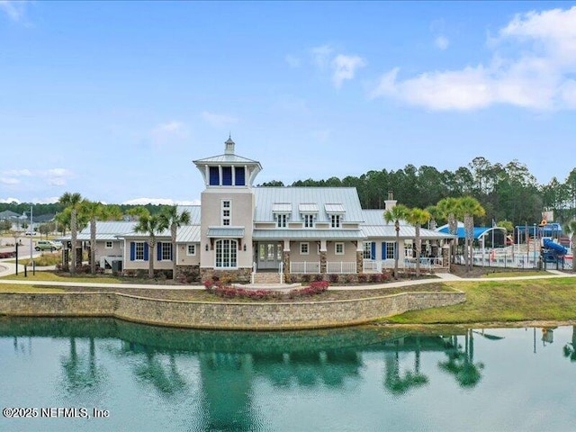 285 Greenway Ln, Saint Augustine, FL 32092 - back of property with a standing seam roof, a water view, metal roof, and a chimney