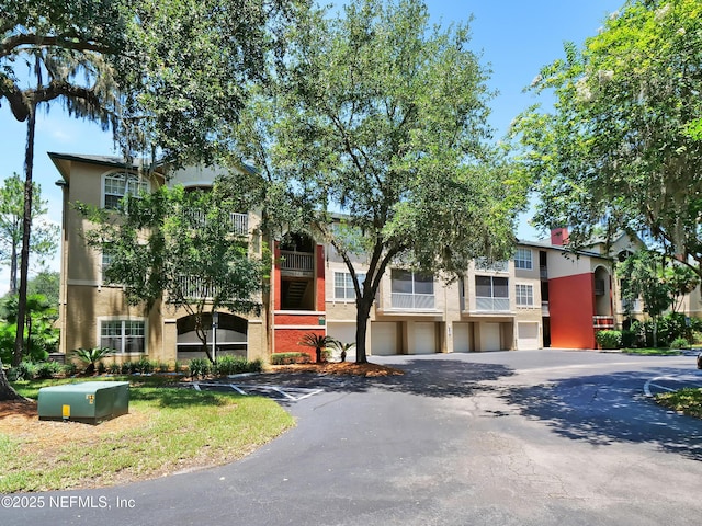 140 Veracruz Dr Unit 635, Ponte Vedra Beach, FL 32082 - view of front of home featuring stucco siding, asphalt driveway, and a garage