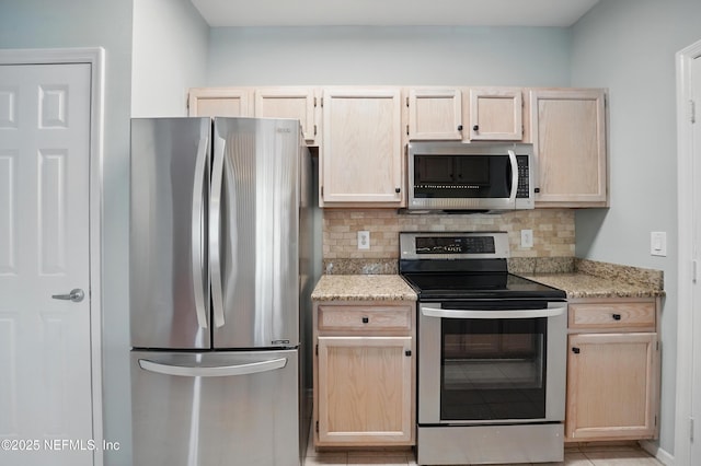 140 Veracruz Dr Unit 635, Ponte Vedra Beach, FL 32082 - kitchen with appliances with stainless steel finishes, light brown cabinets, tasteful backsplash, and light stone countertops