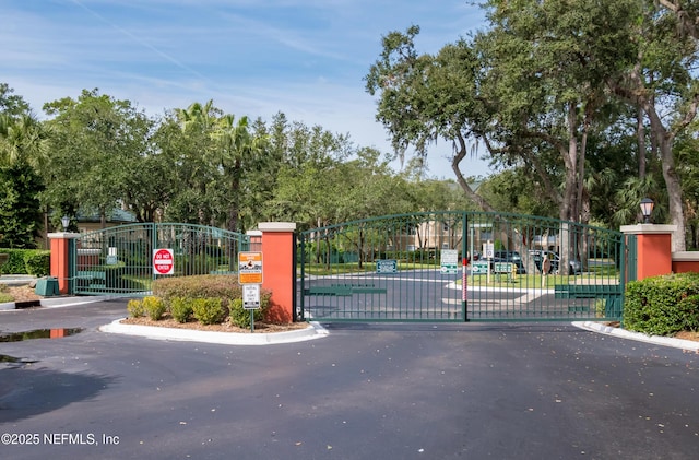 140 Veracruz Dr Unit 635, Ponte Vedra Beach, FL 32082 - view of asphalt street with a gate, traffic signs, and a gated entry