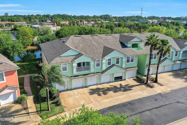13793 Herons Landing Way Unit 4, Jacksonville, FL 32224 - view of front of property with driveway, an attached garage, stucco siding, a shingled roof, and a balcony