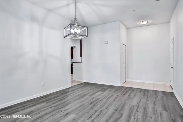 13793 Herons Landing Way Unit 4, Jacksonville, FL 32224 - unfurnished dining area with wood finished floors, a chandelier, and baseboards