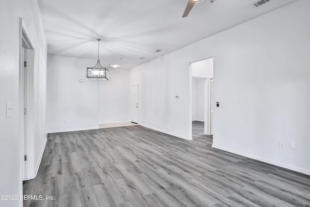 13793 Herons Landing Way Unit 4, Jacksonville, FL 32224 - unfurnished dining area featuring wood finished floors, a ceiling fan, baseboards, and a chandelier