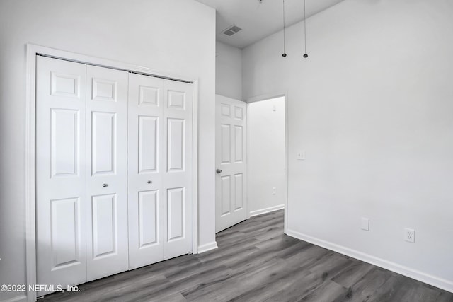 13793 Herons Landing Way Unit 4, Jacksonville, FL 32224 - unfurnished bedroom featuring wood finished floors, a closet, and baseboards