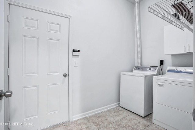 13793 Herons Landing Way Unit 4, Jacksonville, FL 32224 - washroom featuring washer and clothes dryer, cabinet space, baseboards, and light tile patterned floors