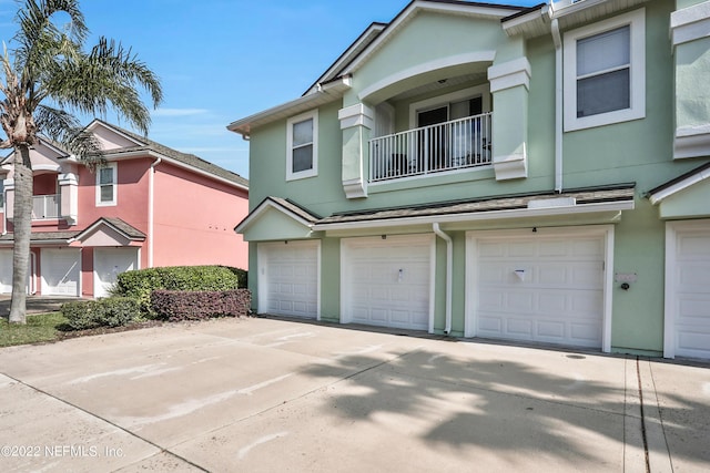 13793 Herons Landing Way Unit 4, Jacksonville, FL 32224 - multi unit property with stucco siding, an attached garage, a balcony, and driveway