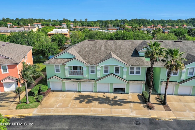 13793 Herons Landing Way Unit 4, Jacksonville, FL 32224 - view of front of property featuring a garage, stucco siding, driveway, and a shingled roof