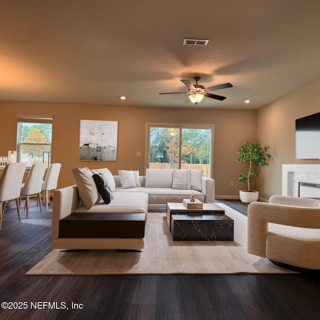 4172 Matador Dr, Jacksonville, FL 32210 - living area featuring wood finished floors, plenty of natural light, a ceiling fan, recessed lighting, and a premium fireplace