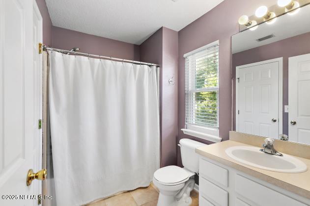 7542 Red Crane Ln, Jacksonville, FL 32256 - full bathroom with vanity, a shower with shower curtain, and tile patterned floors