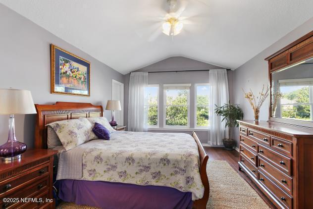 7542 Red Crane Ln, Jacksonville, FL 32256 - bedroom featuring lofted ceiling, dark wood-type flooring, and ceiling fan