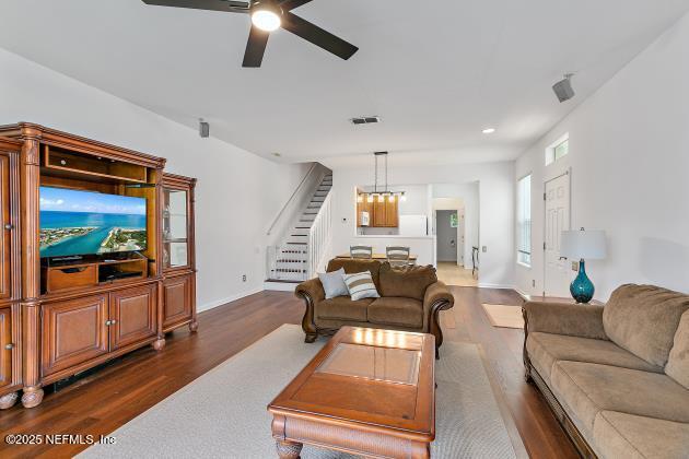 7542 Red Crane Ln, Jacksonville, FL 32256 - living area with wood finished floors, stairway, a ceiling fan, and recessed lighting