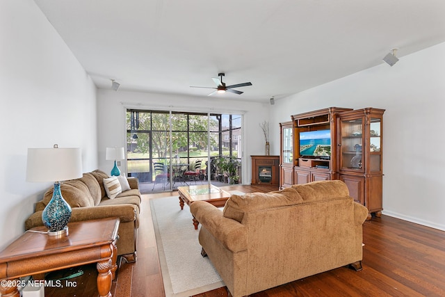 7542 Red Crane Ln, Jacksonville, FL 32256 - living room with ceiling fan, dark wood-style flooring, and a fireplace