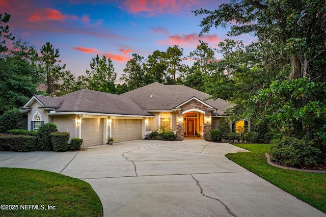 501 Greenbriar Rd, Saint Johns, FL 32259 - ranch-style home with a garage, concrete driveway, stone siding, a lawn, and stucco siding