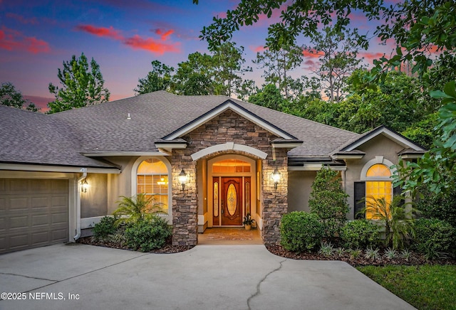 501 Greenbriar Rd, Saint Johns, FL 32259 - view of front of home with stone siding, stucco siding, a shingled roof, and concrete driveway
