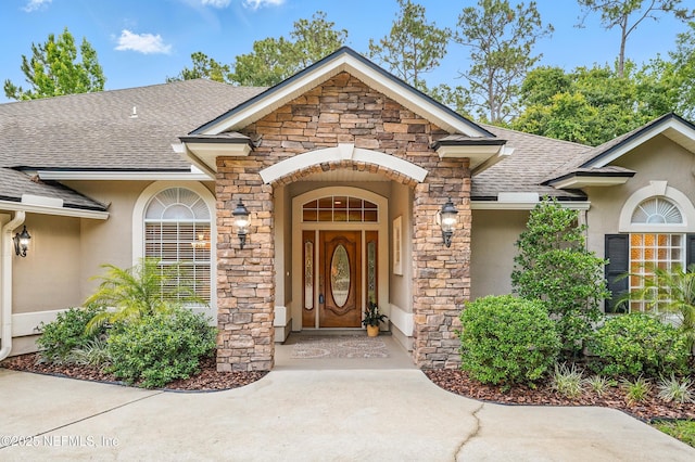 501 Greenbriar Rd, Saint Johns, FL 32259 - property entrance with roof with shingles, stone siding, and stucco siding