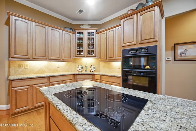 501 Greenbriar Rd, Saint Johns, FL 32259 - kitchen featuring black appliances, light stone countertops, glass insert cabinets, decorative backsplash, and crown molding