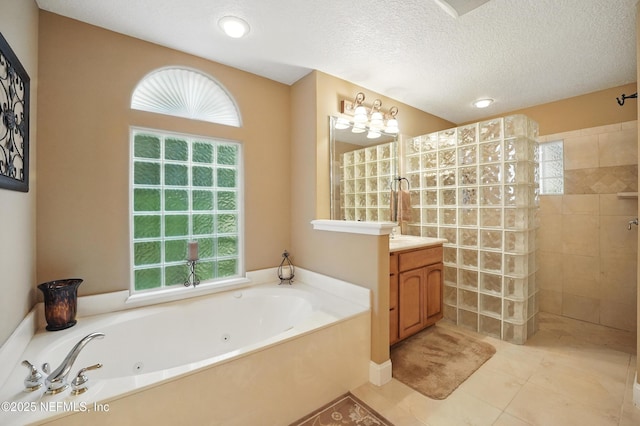 501 Greenbriar Rd, Saint Johns, FL 32259 - full bath with vanity, a tub with jets, walk in shower, tile patterned flooring, and a textured ceiling