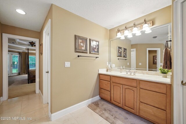501 Greenbriar Rd, Saint Johns, FL 32259 - ensuite bathroom featuring vanity, baseboards, ceiling fan, tile patterned floors, and a textured ceiling