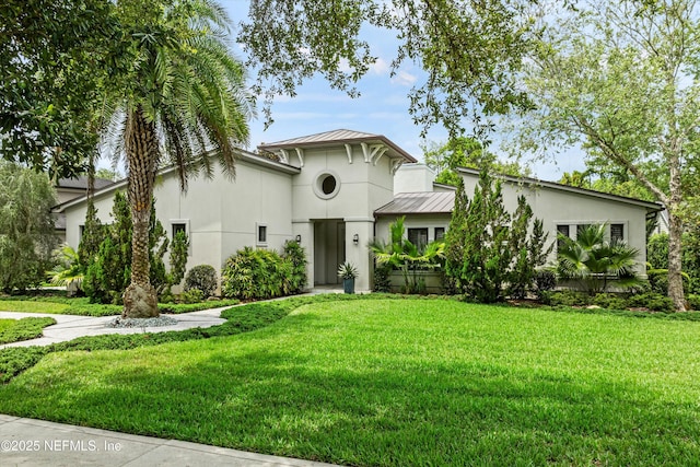 295 Sophia Ter, Saint Augustine, FL 32095 - view of front facade with a standing seam roof, stucco siding, metal roof, and a front lawn
