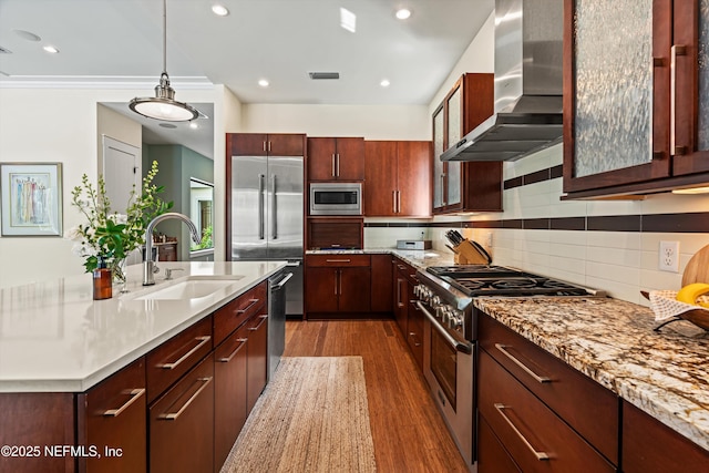 295 Sophia Ter, Saint Augustine, FL 32095 - kitchen with wall chimney exhaust hood, built in appliances, a sink, dark wood-type flooring, and pendant lighting