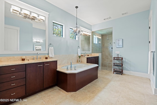 295 Sophia Ter, Saint Augustine, FL 32095 - bathroom with walk in shower, vanity, a garden tub, and a chandelier