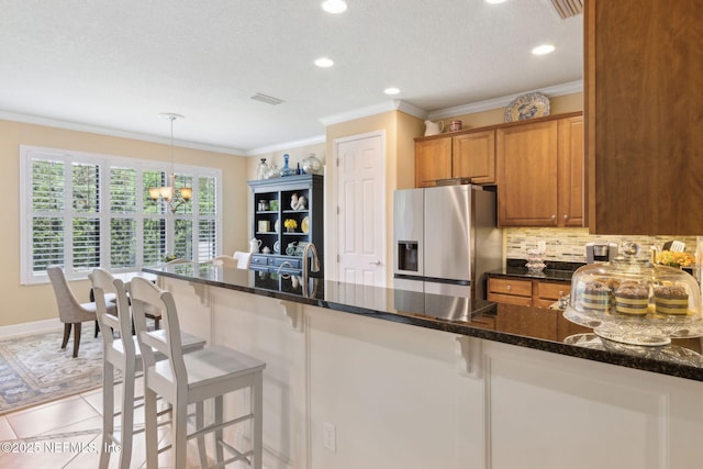 14 Marsh Hollow Rd, Ponte Vedra, FL 32081 - kitchen featuring stainless steel fridge with ice dispenser, a chandelier, decorative backsplash, recessed lighting, and ornamental molding