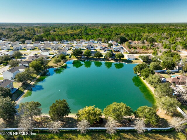 724 Liberty Cir, Macclenny, FL 32063 - aerial perspective of suburban area featuring a heavily wooded area and a large body of water