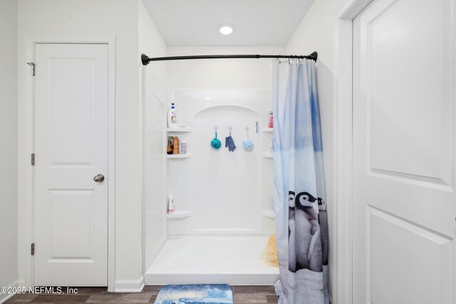 724 Liberty Cir, Macclenny, FL 32063 - bathroom featuring a shower with curtain and wood finished floors