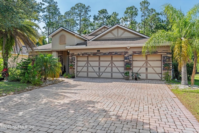 104 Moselle Ln, Jacksonville, FL 32259 - view of front of house featuring stucco siding, an attached garage, decorative driveway, and stone siding