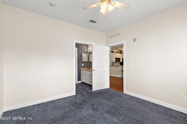 225 Presidents Cup Way Unit 105, Saint Augustine, FL 32092 - unfurnished bedroom with dark carpet, baseboards, and a ceiling fan