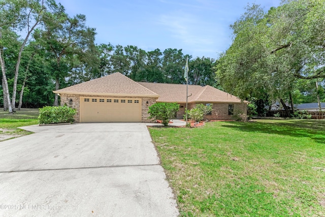 2270 Wilmhurst Rd, Deland, FL 32720 - ranch-style house featuring an attached garage, brick siding, and driveway