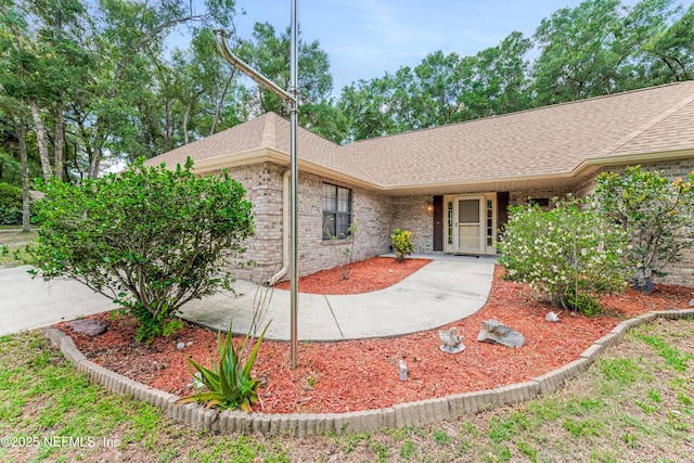 2270 Wilmhurst Rd, Deland, FL 32720 - ranch-style house with a shingled roof and brick siding