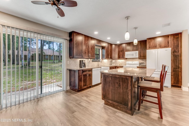 2270 Wilmhurst Rd, Deland, FL 32720 - kitchen featuring white appliances, light wood finished floors, ceiling fan, tasteful backsplash, and recessed lighting