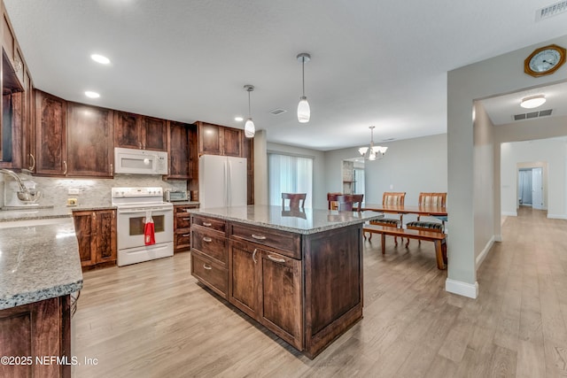 2270 Wilmhurst Rd, Deland, FL 32720 - kitchen featuring white appliances, light wood-style floors, backsplash, decorative light fixtures, and recessed lighting