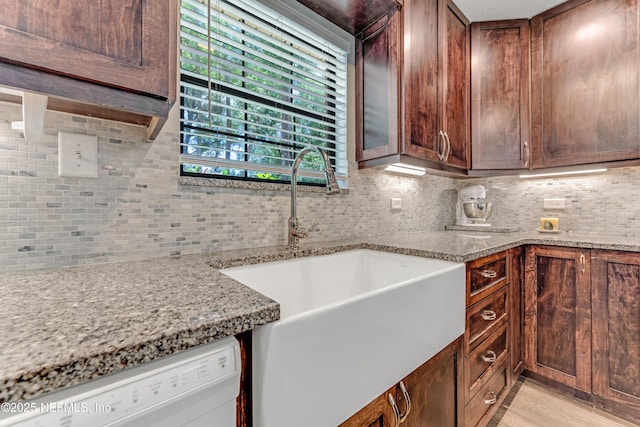 2270 Wilmhurst Rd, Deland, FL 32720 - kitchen featuring white dishwasher, tasteful backsplash, light wood-style flooring, and light stone counters
