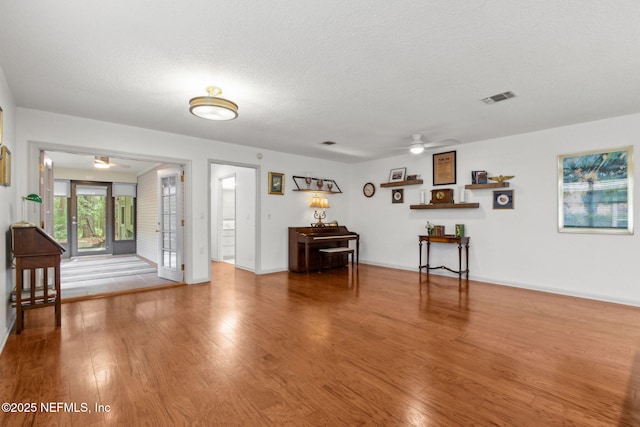 13674 Wm Davis Pkwy, Jacksonville, FL 32224 - living area featuring ceiling fan, wood finished floors, baseboards, and a textured ceiling