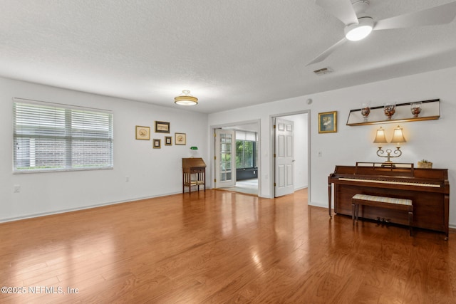 13674 Wm Davis Pkwy, Jacksonville, FL 32224 - living room with a textured ceiling, wood finished floors, a ceiling fan, and baseboards