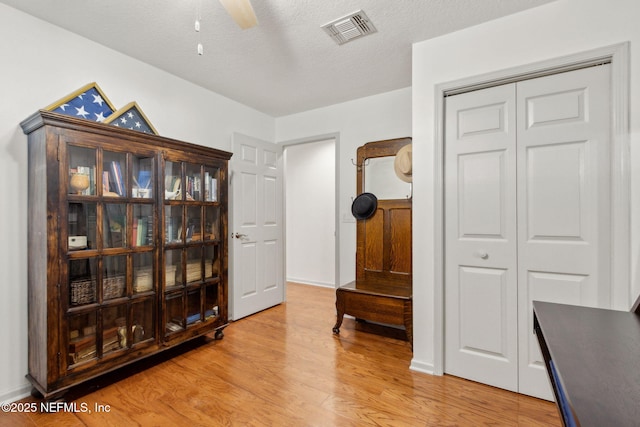 13674 Wm Davis Pkwy, Jacksonville, FL 32224 - living area featuring light wood-type flooring, a textured ceiling, and a ceiling fan