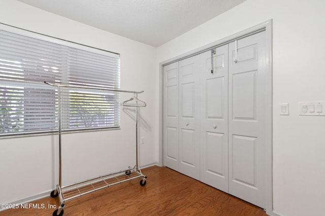 13674 Wm Davis Pkwy, Jacksonville, FL 32224 - unfurnished bedroom with wood finished floors, a closet, and baseboards