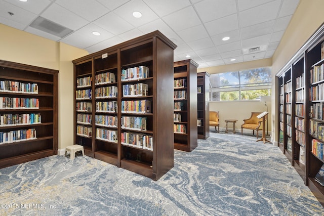 13674 Wm Davis Pkwy, Jacksonville, FL 32224 - living area with wall of books, a drop ceiling, baseboards, recessed lighting, and carpet