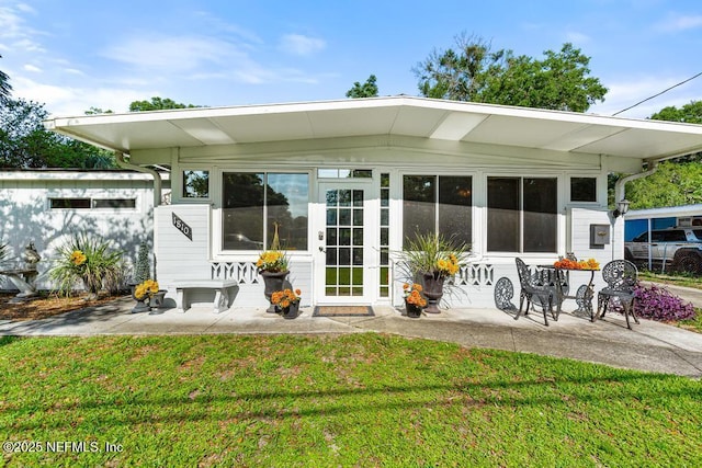 1810 Griflet Rd, Jacksonville, FL 32211 - rear view of house featuring a patio area and a lawn