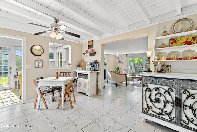 1810 Griflet Rd, Jacksonville, FL 32211 - dining room featuring ceiling fan, light marble finish floors, and wood ceiling with exposed beams