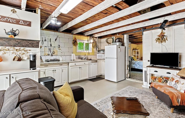 1810 Griflet Rd, Jacksonville, FL 32211 - living area featuring concrete floors and wooden ceiling with exposed beams