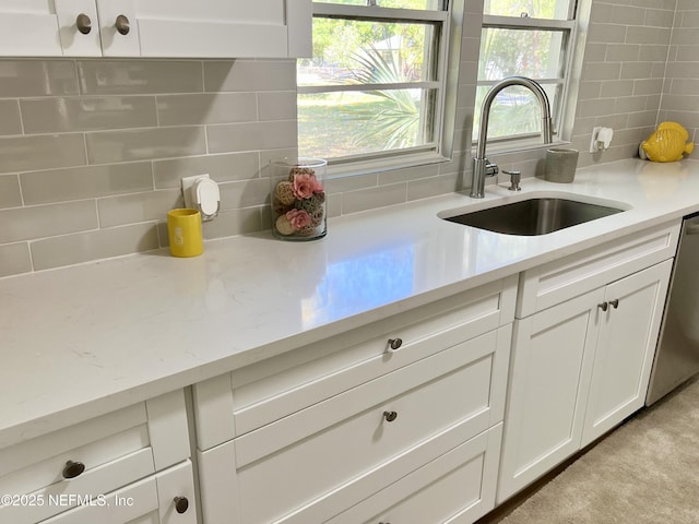 5256 Alpha Ave, Jacksonville, FL 32205 - kitchen featuring a sink, backsplash, white cabinetry, and dishwasher
