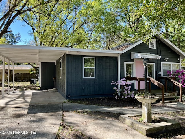 5256 Alpha Ave, Jacksonville, FL 32205 - view of front facade with driveway, a carport, and central AC