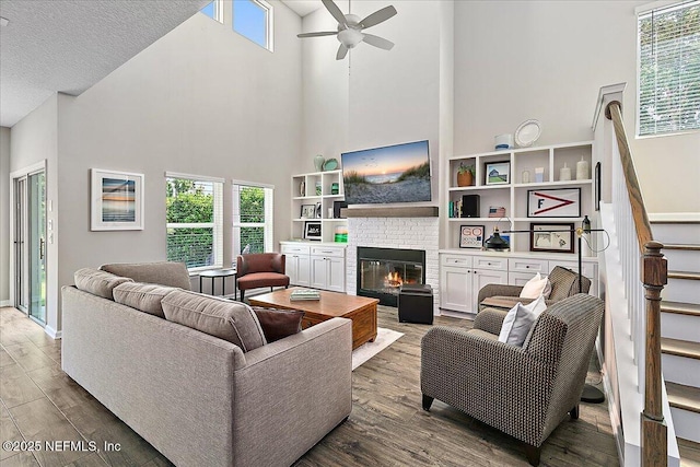 436 Marsh Cove Dr, Ponte Vedra Beach, FL 32082 - living area with a towering ceiling, a ceiling fan, stairs, wood finished floors, and a fireplace