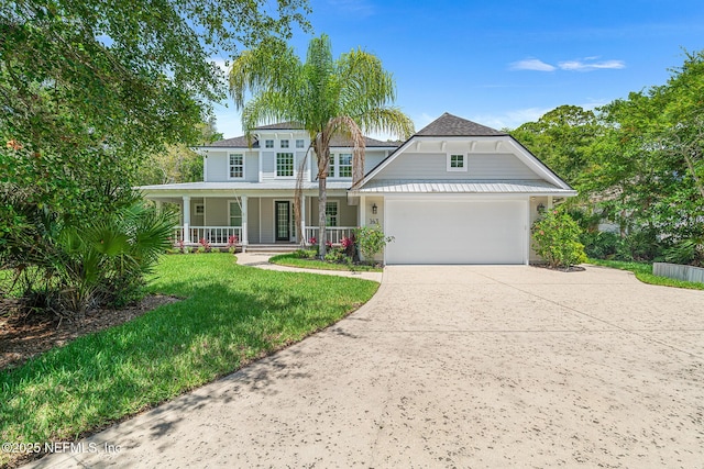 143 Istoria Dr, Saint Augustine, FL 32095 - view of front of home with a porch, driveway, a front lawn, and a garage