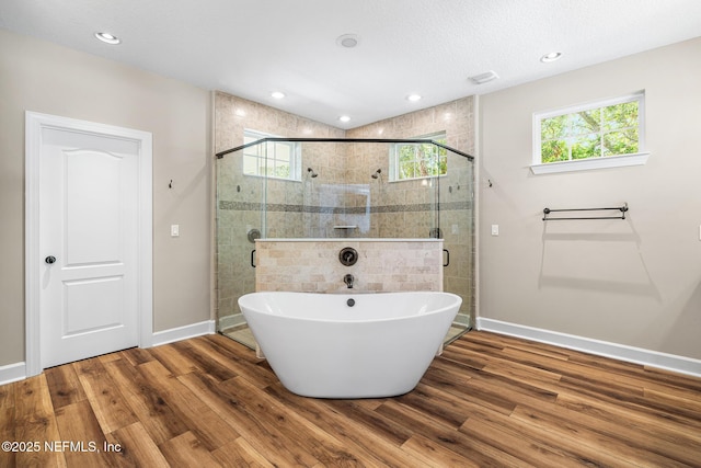 143 Istoria Dr, Saint Augustine, FL 32095 - full bathroom featuring wood finished floors, a freestanding tub, baseboards, plenty of natural light, and recessed lighting